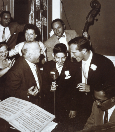 Bill Elgart with family and friends including father on piano, mother in white, uncles on each side sharing the microphone and Michael Kaye’s father, Eddie Kaye playing bass in Massachusetts in 1955